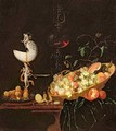 A Still Life of fruit with a nautilus cup on a draped ledge - Georg Hinz