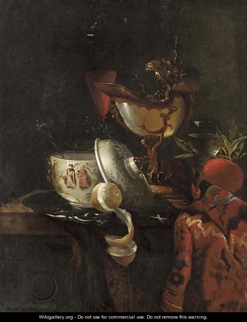 A nautilus cup, an oriental bowl on a silver tray and glasses of wine on a table - (after) Willem Kalf