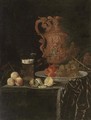 A gilt ewer, a roemer of beer, peaches, a partly-peeled lemon on a pewter tray, and grapes and peaches in a porcelain dish on a partly-draped table - Johann Georg (also Hintz, Hainz, Heintz) Hinz