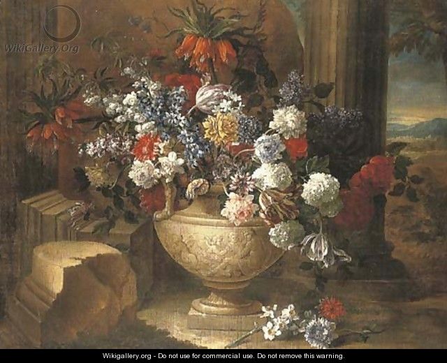 Tulips, lilacs, dahlias and other flowers in a sculpted vase, before a column, a landscape beyond - Jean-Baptiste Monnoyer
