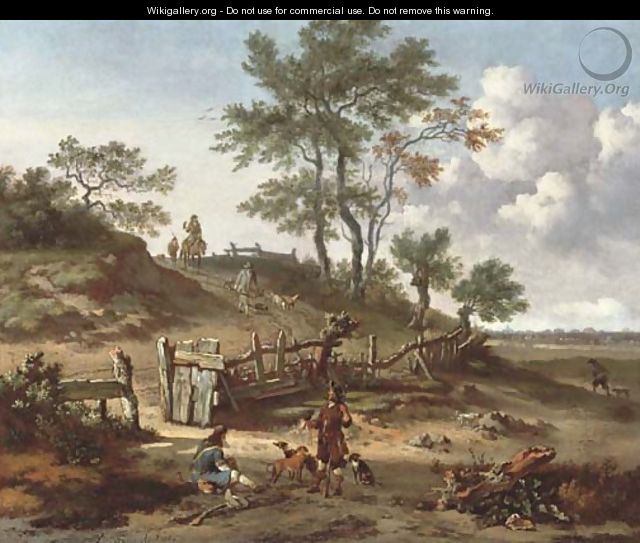 A hilly landscape with a huntsman and a falconer resting by a gate and other huntsmen on a path - Jan Wijnants