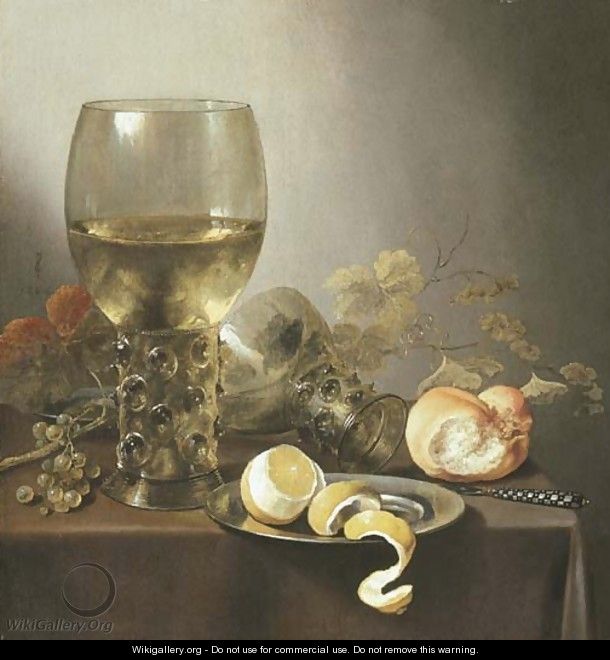 A giant roemer, an upturned roemer, grapes on the vine, a roll of bread, a knife and a partly-peeled lemon on a platter on a draped table - Pieter Claesz.