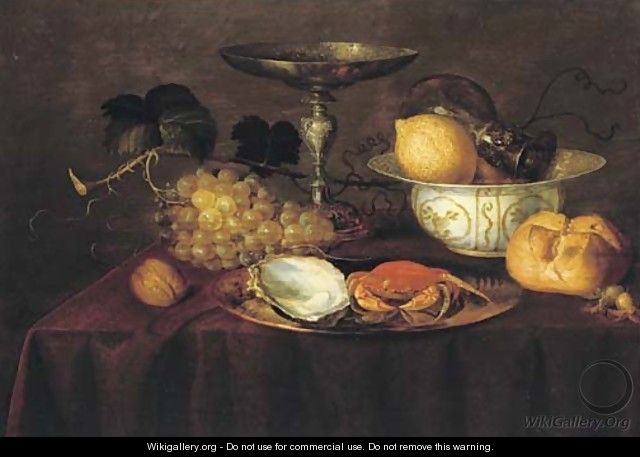 A silver dish with an oyster and a crab, a walnut, white grapes, a silver 