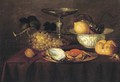 A silver dish with an oyster and a crab, a walnut, white grapes, a silver 'tazza', a porcelain bowl - Theodoor Smits