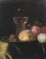 A roemer of white wine, a bread roll and nuts on a silver plate, together with roses on a green-draped table - Simon Luttichuys