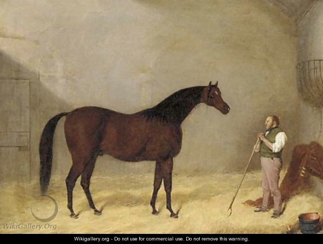 A bay hunter with a groom in a stable - Martin Theodore Ward