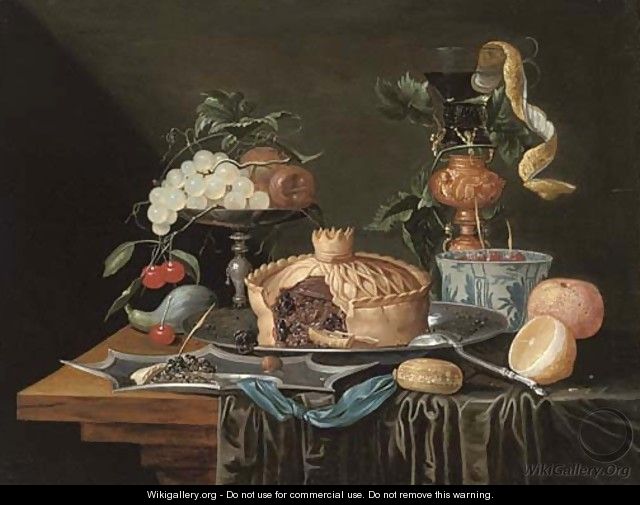 A pie on a pewter plate, grapes and cherries on a pewter tazza, a partly-peeled lemon in a glass roemer and a Dutch delft blue - Christian Luycks