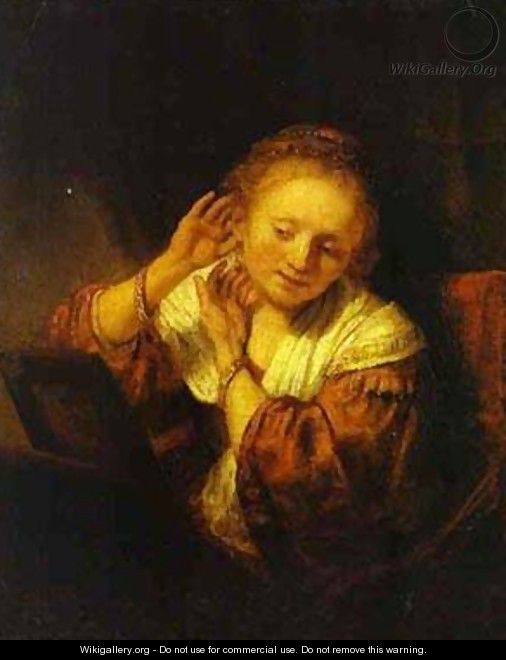 A Young Woman Trying On Earings 1657 - Harmenszoon van Rijn Rembrandt