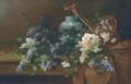Carnations, hyacinths and other summer flowers overflowing from a basket by a vase on a draped table - Alfred Rouby