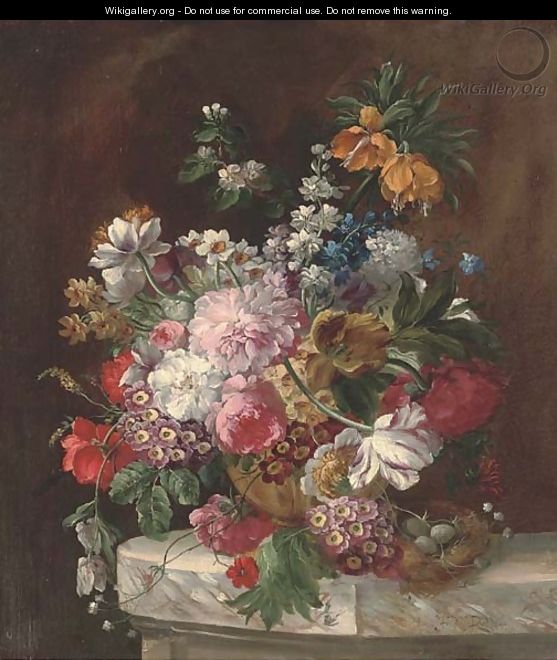 Roses, tulips, chrysanthemums, narcissae and other summers blooms in an urn by a bird