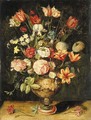 Tulips, irises, roses, carnations, lilies, narcissi and other flowers in a sculpted urn on a table - Andries Daniels or Danielsz