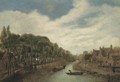 A river landscape with figures on a path by a village - (after) Cornelius Decker