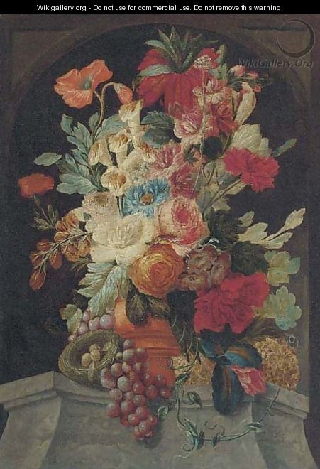 Mixed flowers in an urn on a ledge with grapes and a bird
