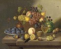 A still life of grapes, pears and apples in a wicker basket and plums, lemons and a peach on a ledge - Continental School