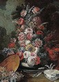 Still life of flowers in a vase with a porcelain bowl, in a garden setting - (after) Gasparo Lopez