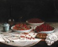 Still Life With Redcurrants, Cherries And Strawberries In Porcelain Bowls, Together With A Bread Roll, A Bottle Of Wine And A Porcelain Pot Together On A White Table Cloth On A Wooden Table - French School