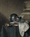 A Still Life With A Pewter Jug On Its Side, A Glass Of Beer And Walnuts On Pewter Dishes - Simon Luttichuys