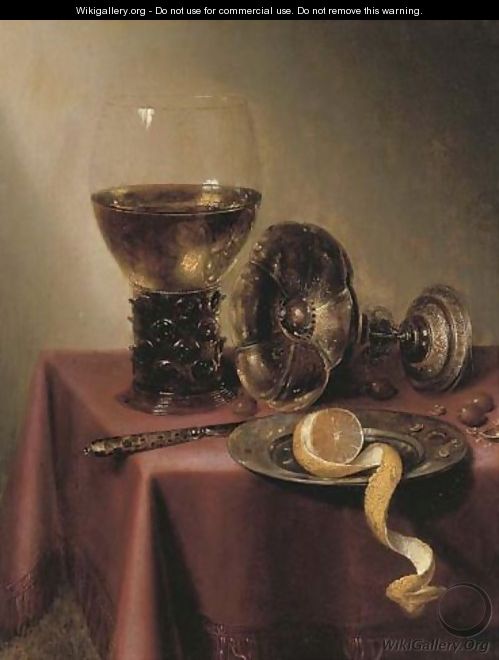 An upturned silver tazza, hazelnuts, a peeled lemon on a pewter platter, a knife and a roemer, on a draped table - Maerten Boelema De Stomme