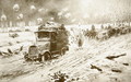 British Transport train making its way under heavy shell fire along the snow-bound Ypres roads - (after) Villiers, Frederic