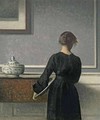 Young Woman from Behind - Vilhelm Hammershoi