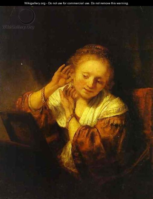 A Young Woman Trying on Earings - Rembrandt Van Rijn