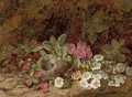 A bird's nest with primulas, pansies and blossom on a mossy bank - George Clare