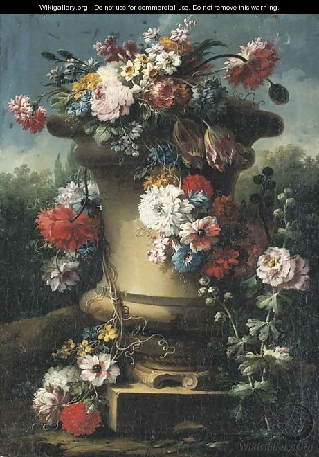 Narcissi, tulips, chrysanthemums, roses and other flowers in a stone urn with hollyhocks, a wooded landscape beyond - Gasparo Lopez