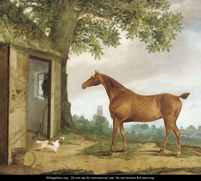 A chestnut hunter and spaniel before a stable, a church beyond - G.B. Newmarch