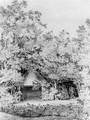 A labourer approaching a thatched pavilion in a garden - John Constable