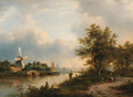 A river landscape in autumn with villagers on a path along the water, a town beyond - Lodewijk Johannes Kleijn