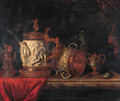 A pronk still life with a gilt dish, a gilt cup and cover, a bronze sculpture of a seated putto, an ormulo mounted carved ivory tankard - Pieter Gerritsz. van Roestraeten