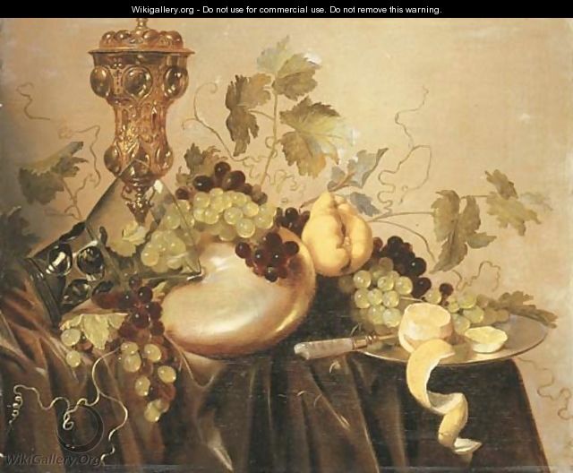 A silver-gilt cup and cover, an upturned roemer resting on a nautilus shell, grapes on the vine and a partly-peeled lemon with a knife - Pieter Nason