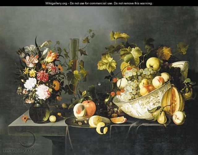 Tulips, carnations and other flowers in a vase, grapes and peaches in a porcelain bowl, with glasses of wine, a peeled lemon on a dish and other fruit - Michiel Simons