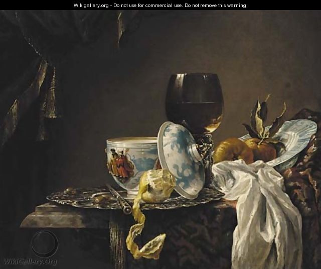 A still life of china, a goblet, fruit and a peeled lemon on a table - (after) Willem Kalf