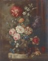 Roses, petunias, dahlias, campanulae and other summer flowers in an ornamental urn with bunches of grapes on a garden plinth - (after) Huysum, Jan van
