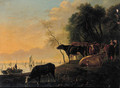 Cowherds and cattle on a riverbank on a summer