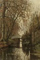 An autumn forest with a washerwoman near a bridge - Petrus Paulus Schiedges