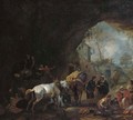 A grotto with travellers unloading a wagon, a gypsy fortune-teller, a blacksmith and other figures - Philips Wouwerman