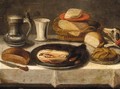 Still Life Of A Pewter Plate With A Jan Steen Jug, A Cup, A Basket Of Bread, And A Dog On A Table - (after) Jacob Foppens Van Es