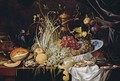 A Dutch Delft blue and white bowl with grapes, prawns on a pewter plate, crabs, a partly-peeled lemon and a melon on a partly-draped table - Alexander Coosemans