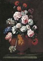 Roses, carnations, tulips and other flowers in a sculpted urn on a stone ledge - (after) Giovanni Stanchi