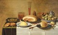 Mulberries, a ham and a bun on pewter plates, butter and pears on porcelain dishes with a beerglass, a flute and a knife on a draped table - Floris Gerritsz. van Schooten