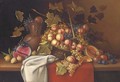 Still life of melons, plums, lemons, grapes and peaches in a basket, on a table - Dutch School