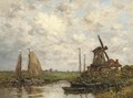 Barges moored before a windmill in a Dutch landscape - Dutch School