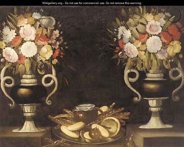 Mixed flowers in a pair of urns, bread, a jug of wine and figs on a silver dish on a ledge - (after) Tomas Hiepes