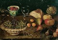 Still life of a bowl of grapes and raspberries in a blue and white cup, together with other fruits - (after) Osias, The Elder Beert