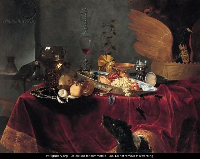 A Pronk Still Life Of Fruit And Silver, Porcelain And Glassware, All On A Table Draped With A Red Cloth, Observed By A Dog - Gerard Van Berleborch