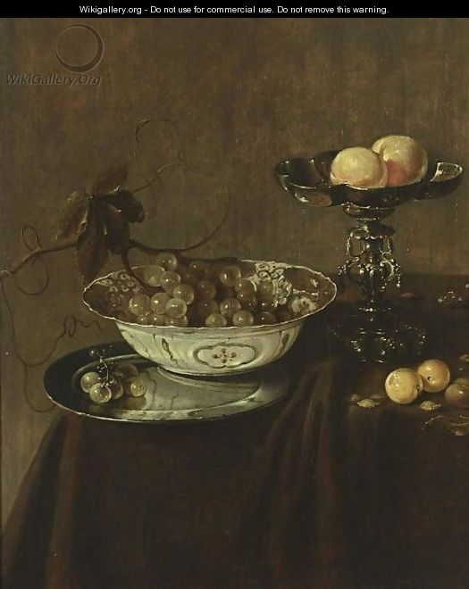 A Still Life With A Wan-Li Porcelain Bowl With Grapes On A Pewter Plate, A Silver Tazza With Peaches, Together With Plums And Nuts, All On A Draped Table - Jan Jansz. Treck