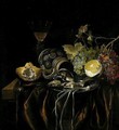 A Still Life Of A Siegburger Kanne, Herring, And A Spring Onion On A Silver Plate, Grapes, A Peeled Lemon, A Bread Roll And A Glass With Wine, All Upon A Table Draped With A Red Cloth - Cornelis van Lelienbergh