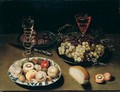 Still Life Of Peaches, Figs, Apples And Walnuts In A Blue And White Porcelain Bowl, Together With Grapes And Plums In Pewter Dishes, Wine Glasses, Bread And A Knife, All Arranged Upon A Table Top - Osias, the Elder Beert